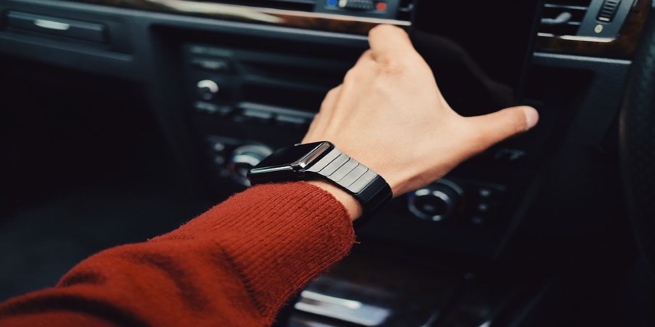 Man In Car Reaching For Smartphone