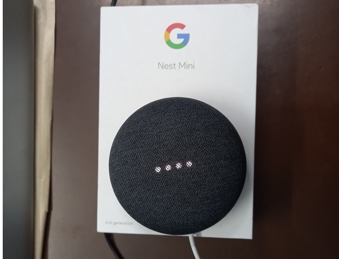 Google Home/Nest speaker in listening mode with four white lights blinking