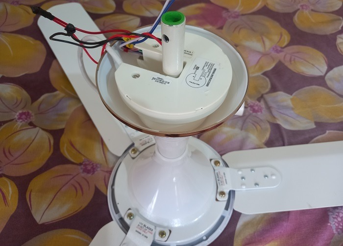 Microcontroller inserted over bottom cover of fan using its rod and canopy.