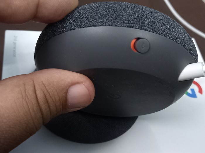 Feel for signs of physical damage on a Nest speaker.