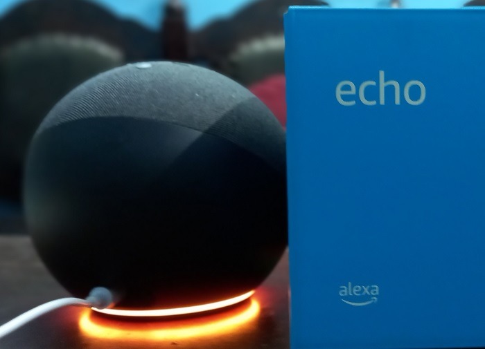 Echo speaker in orange setup mode with clear ring indicating factory reset of Alexa.