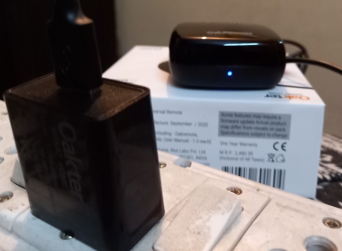 LED light blinking with smart universal IR remote plugged into an outlet.