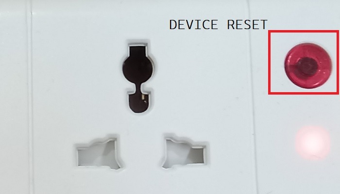 Close up of a device reset button on a smart power strip with lights blinking rapidly.