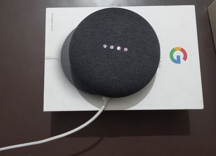 Nest Mini in listening mode indicated by four white lights flashing regularly.