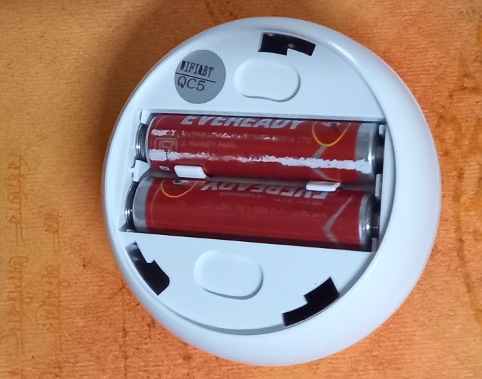 Insert batteries inside motion sensor lights.