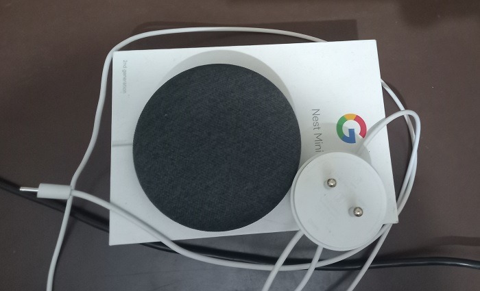 Nest Mini completely unplugged with charging points and plug not connected.