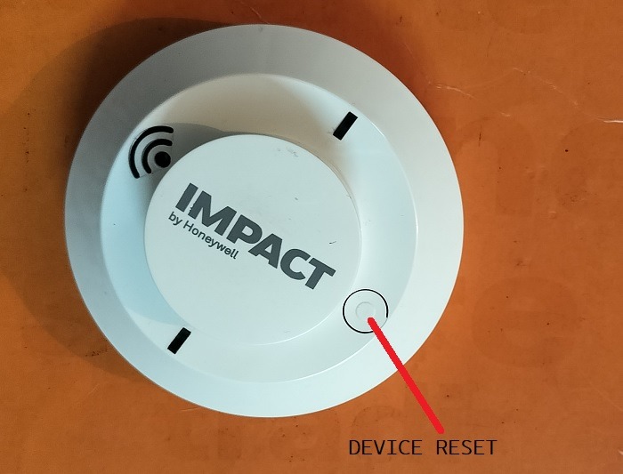 Device reset button in wireless smoke detector. 